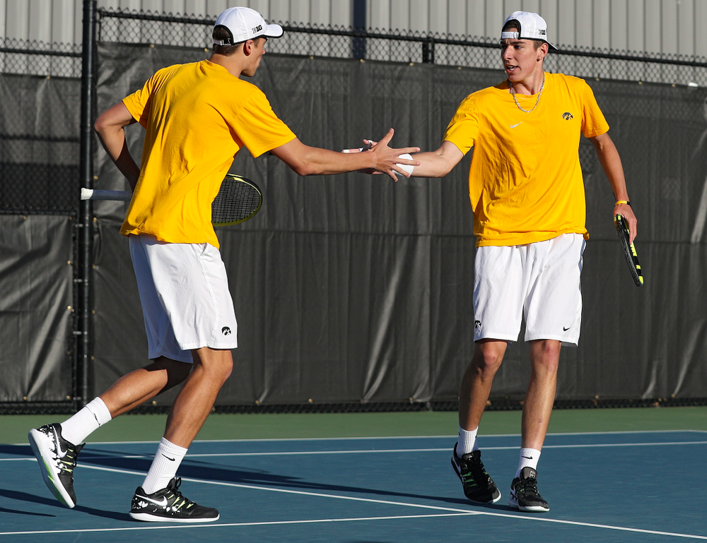 Iowa's Joe Tyler (from left) and Nikita Snezhko celebrate a point during their doubles match again Michigan State at the Hawkeye Tennis and Recreation Complex in Iowa City on Friday, Apr. 19, 2019. (Stephen Mally/hawkeyesports.com)