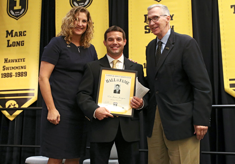 Barb Randall (from left), co-chair of the Varsity Club Advisory Committee, 2019 University of Iowa Athletics Hall of Fame inductee Eric Juergens, and Andy Piro, assistant athletics director and executive director of the Varsity Club, during the Hall of Fame Induction Ceremony at the Coralville Marriott Hotel and Conference Center in Coralville on Friday, Aug 30, 2019. (Stephen Mally/hawkeyesports.com)