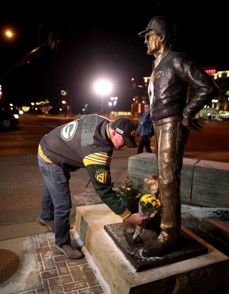 Mourners lay flowers at the statue of former Hawkeye Football Head Coach Hayden Fry Tuesday, December 17, 2019 in Coralville. Fry passed away on Tuesday at the age of 90. (Brian Ray/hawkeyesports.com)