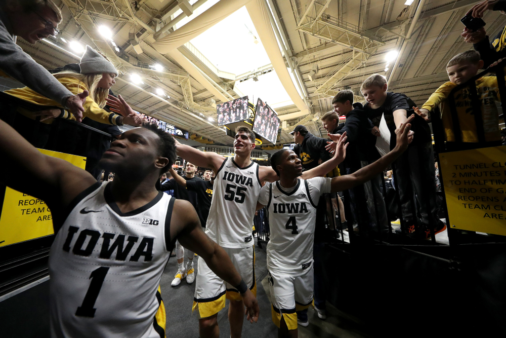 Iowa Hawkeyes guard Joe Toussaint (1), forward Luka Garza (55), and guard Bakari Evelyn (4) celebrate their win against Penn State Saturday, February 29, 2020 at Carver-Hawkeye Arena. (Brian Ray/hawkeyesports.com)