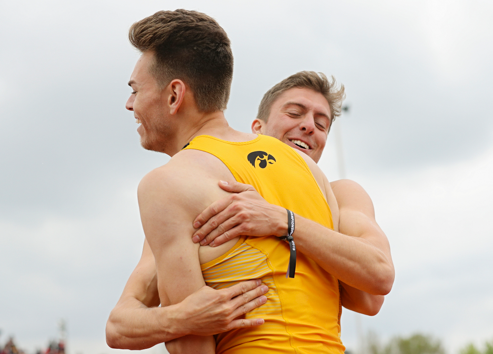 Iowa's Chris Douglas (from left) gets a hug from Noah Larrison after Douglas won the men’s 400 meter hurdles event on the third day of the Big Ten Outdoor Track and Field Championships at Francis X. Cretzmeyer Track in Iowa City on Sunday, May. 12, 2019. (Stephen Mally/hawkeyesports.com)