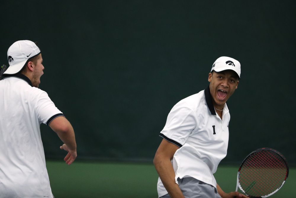 Iowa's Will Davies and Oliver Okonkwo celebrate after winning a doubles match against Western Michigan Saturday, January 19, 2019 at the Hawkeye Tennis and Recreation Complex. (Brian Ray/hawkeyesports.com)