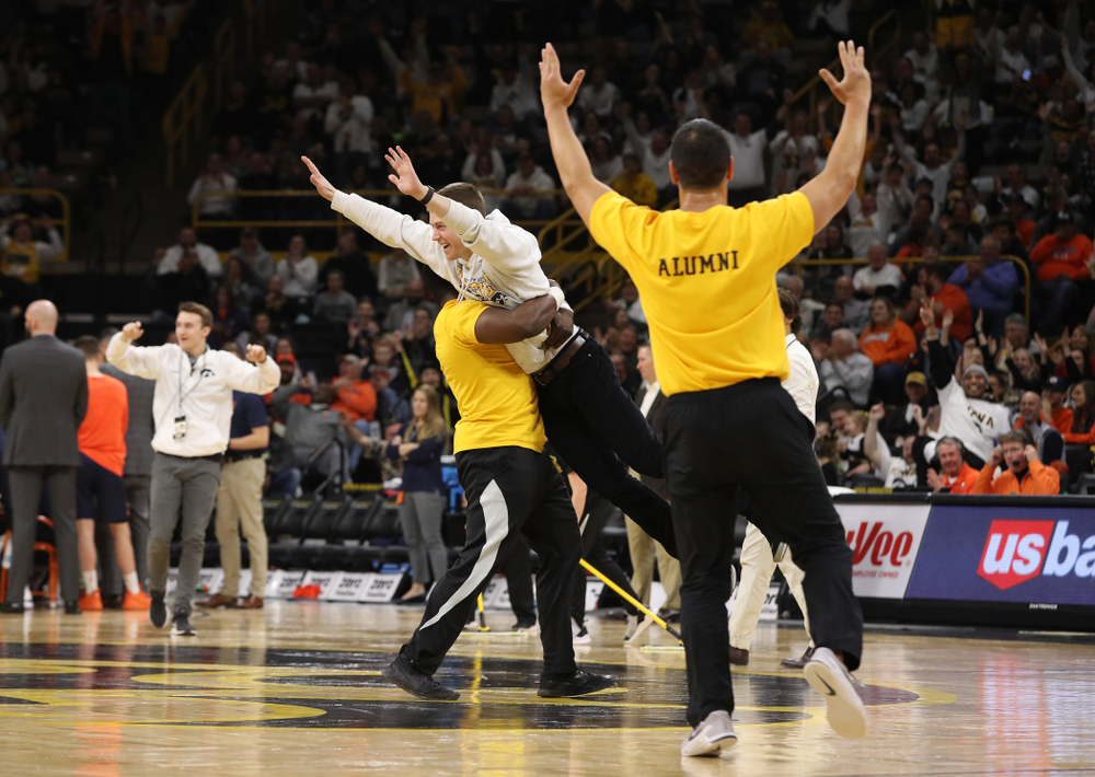 A fan celebrates after making a half court shot during the Iowa Hawkeyes game against the Illinois Fighting Illini Sunday, January 20, 2019 at Carver-Hawkeye Arena. (Brian Ray/hawkeyesports.com)