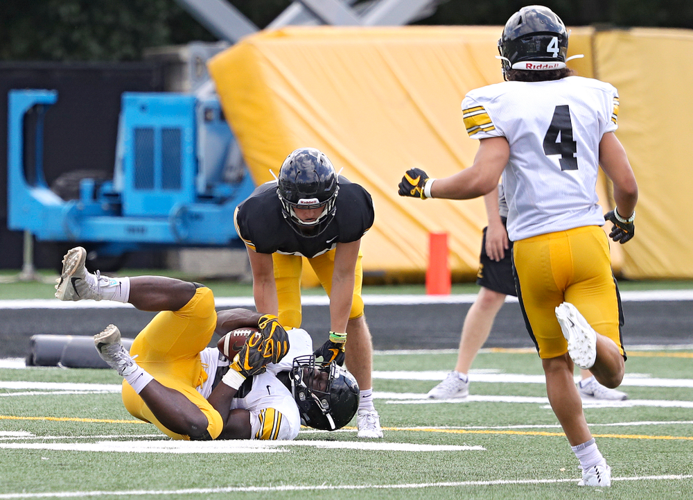 Iowa Hawkeyes linebacker Amani Jones (52) intercepts a pass as wide receiver Alec Kritta (83) looks on during Fall Camp Practice No. 11 at the Hansen Football Performance Center in Iowa City on Wednesday, Aug 14, 2019. (Stephen Mally/hawkeyesports.com)