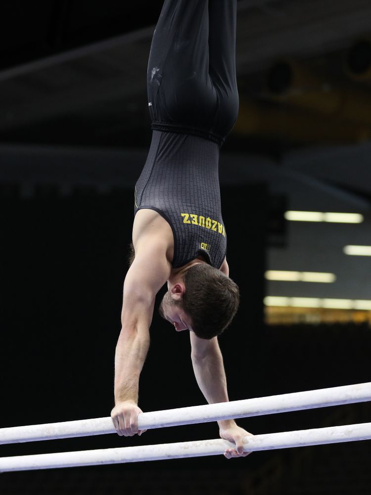 Iowa's Rogelio Vazquez competes on the parallel bars against the Ohio State Buckeyes Saturday, March 16, 2019 at Carver-Hawkeye Arena. (Brian Ray/hawkeyesports.com)