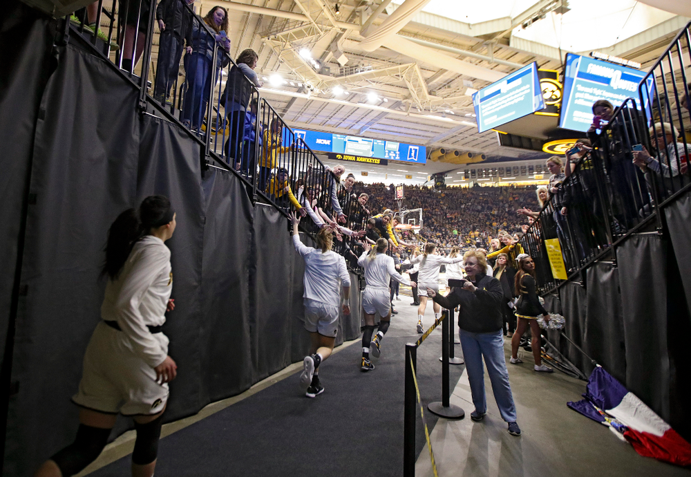 The Iowa Hawkeyes run onto the court before their second round game in the 2019 NCAA Women's Basketball Tournament at Carver Hawkeye Arena in Iowa City on Sunday, Mar. 24, 2019. (Stephen Mally for hawkeyesports.com)