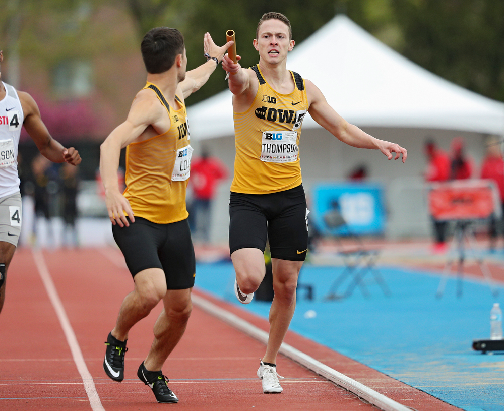 Iowa's Chris Thompson (right) hands the baton off to Carter Lilly during the 1600 meter relay event on the third day of the Big Ten Outdoor Track and Field Championships at Francis X. Cretzmeyer Track in Iowa City on Sunday, May. 12, 2019. (Stephen Mally/hawkeyesports.com)