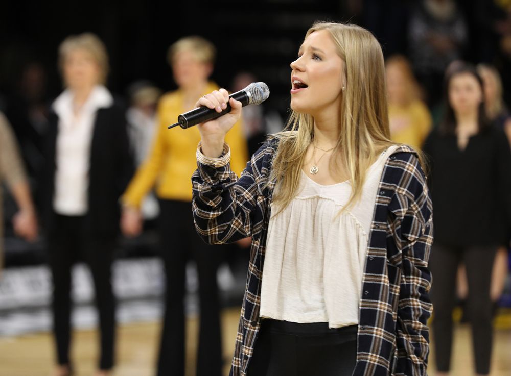 Iowa Hawkeyes head coach Lisa Bluder watches as her daughter Emma sings the National Anthem before the Iowa Hawkeyes game against the Northwestern Wildcats Sunday, March 3, 2019 at Carver-Hawkeye Arena. (Brian Ray/hawkeyesports.com)