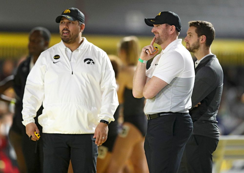 Iowa director of track and field Joey Woody (right) laughs as he talks with assistant coach/recruiting coordinator Jason Wakenight between the men’s and women’s 1600 meter relay event during the Hawkeye Invitational at the Recreation Building in Iowa City on Saturday, January 11, 2020. (Stephen Mally/hawkeyesports.com)