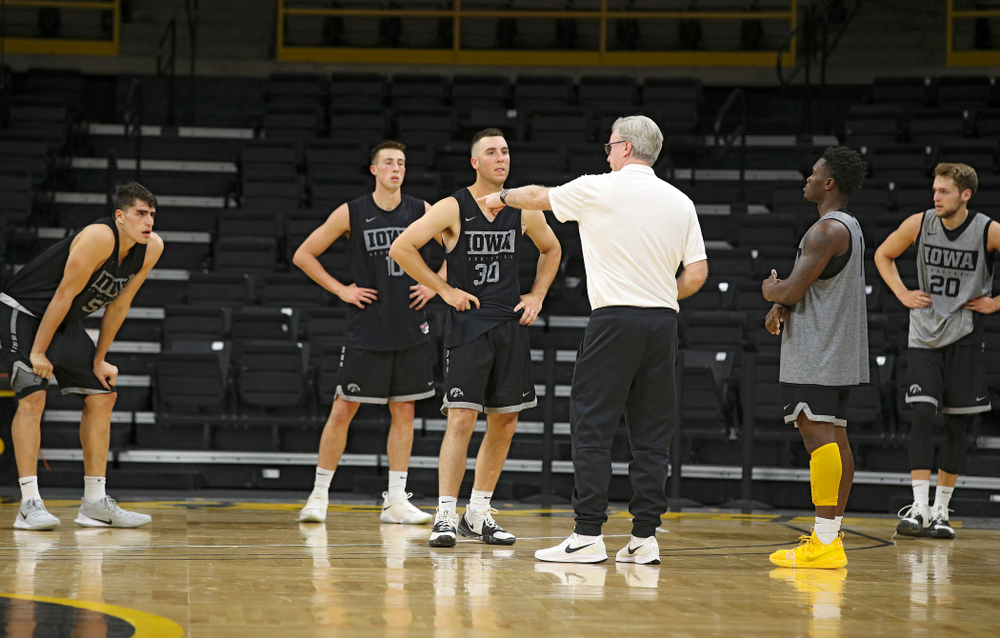 Iowa Hawkeyes head coach Fran McCaffery talks with center Luka Garza (55), guard Joe Wieskamp (10), guard Connor McCaffery (30), guard Joe Toussaint (1), and forward Riley Till (20) during practice at Carver-Hawkeye Arena in Iowa City on Monday, Sep 30, 2019. (Stephen Mally/hawkeyesports.com)