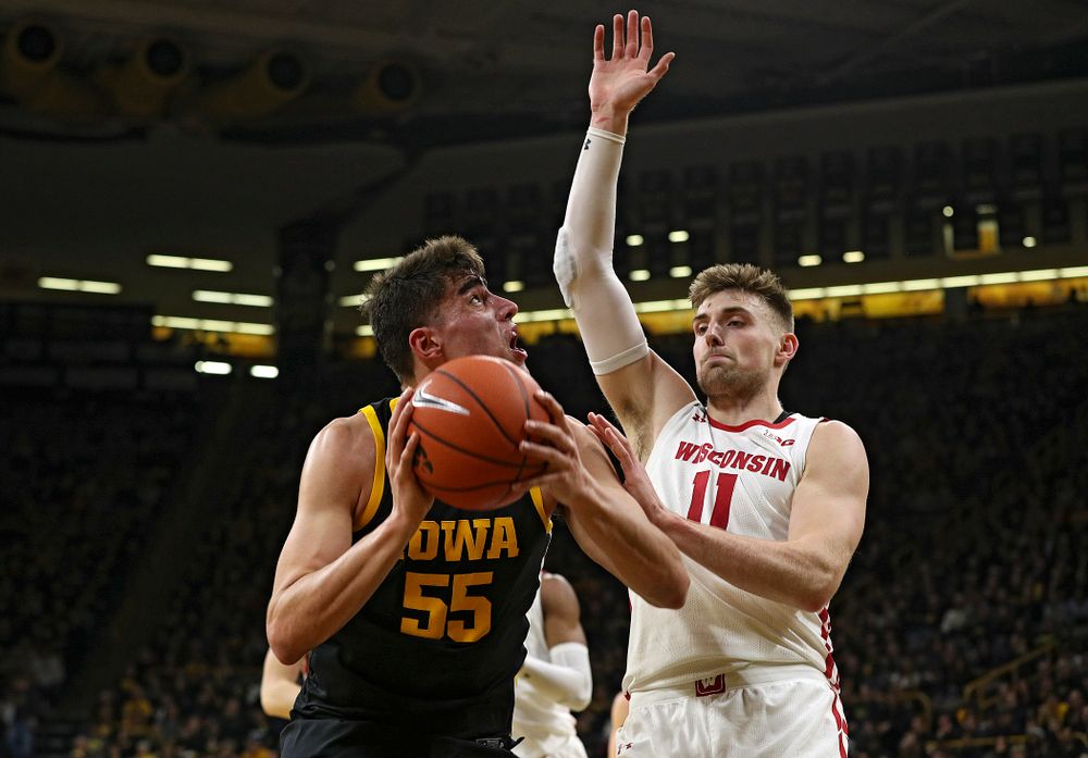 Iowa Hawkeyes center Luka Garza (55) eyes the basket before scoring around Wisconsin Badgers forward Micah Potter (11) during the first half of their game at Carver-Hawkeye Arena in Iowa City on Monday, January 27, 2020. (Stephen Mally/hawkeyesports.com)