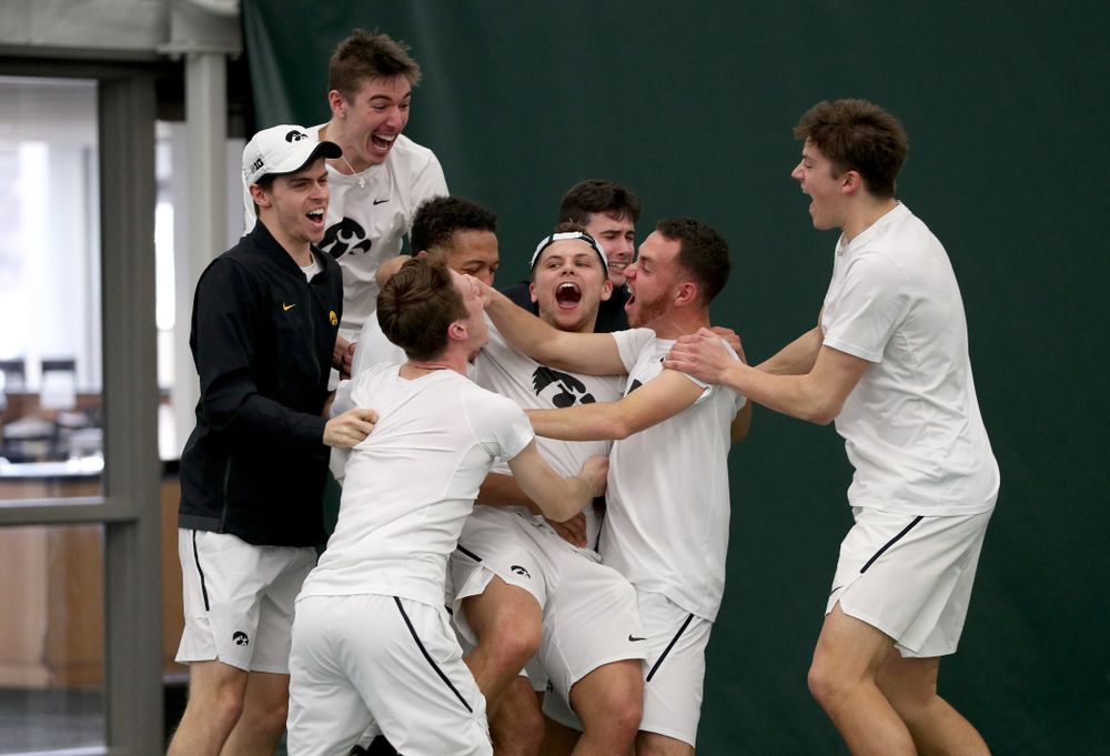 Iowa’s Will Davies celebrates with his teammates after defeating Cornell’s Lev Kazakov in three sets to clench at 4-3 victory Sunday, March 8, 2020 at the Hawkeye Tennis and Recreation Center. (Brian Ray/hawkeyesports.com)