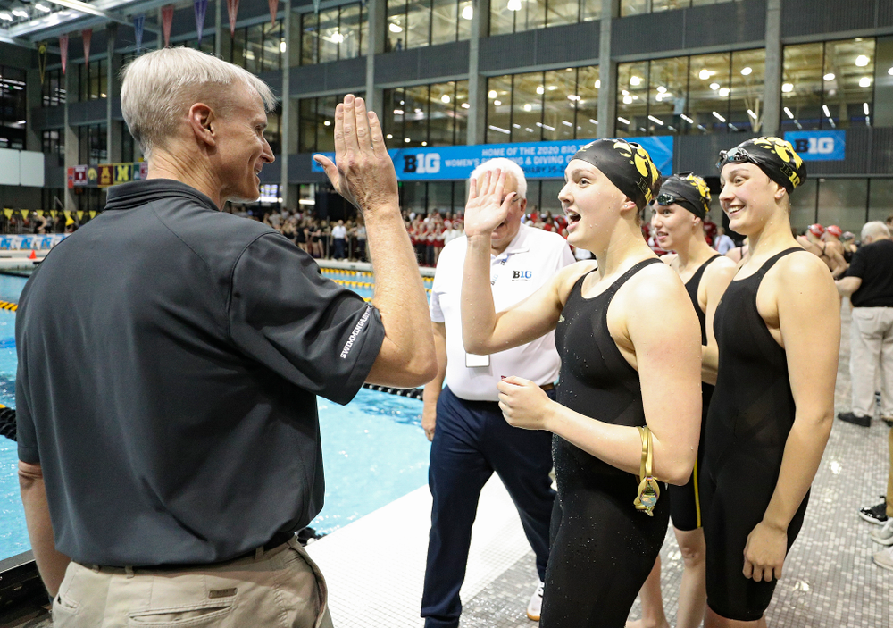 Iowa head coach Marc Long greets Hannah Burvill, Allyssa Fluit, and Emilia Sansome after they placed fourth in the 800 yard freestyle relay event during the 2020 Big Ten Women’s Swimming and Diving Championships at the Campus Recreation and Wellness Center in Iowa City on Wednesday, February 19, 2020. (Stephen Mally/hawkeyesports.com)