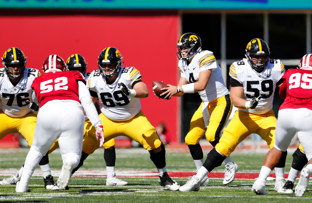 Iowa Hawkeyes offensive lineman Dalton Ferguson (76), offensive lineman Keegan Render (69), and offensive lineman Ross Reynolds (59) block for quarterback Nate Stanley (4) against the Indiana Hoosiers Saturday, October 13, 2018 at Memorial Stadium, in Bloomington, Ind. (Brian Ray/hawkeyesports.com)