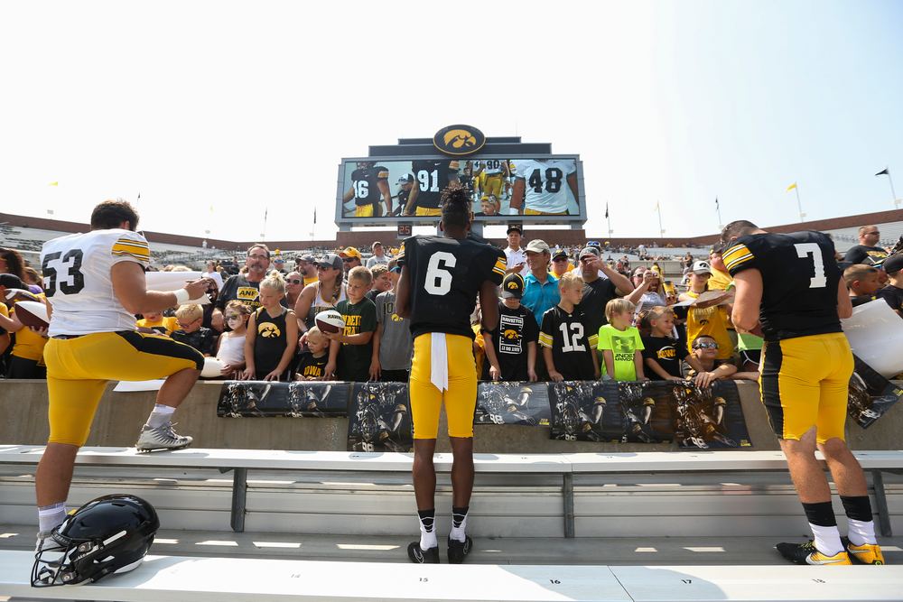 Iowa Hawkeyes defensive lineman Garret Jansen (53), Iowa Hawkeyes wide receiver Ihmir Smith-Marsette (6), Iowa Hawkeyes quarterback Spencer Petras