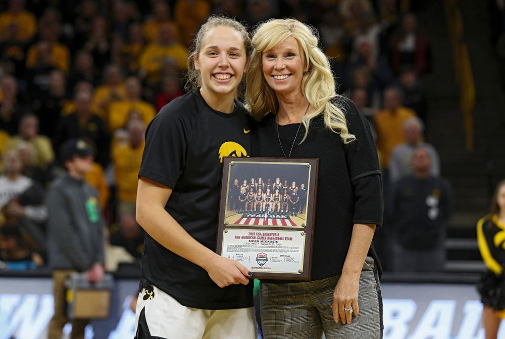 Iowa Hawkeyes guard Kathleen Doyle (22) is honored as a member of Team USA’s 2019 Pan American Games team by the team’s head coach Michigan State Spartans head coach Suzy Merchant before the start of their game at Carver-Hawkeye Arena in Iowa City on Sunday, January 26, 2020. (Stephen Mally/hawkeyesports.com)
