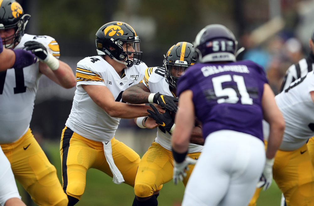 Iowa Hawkeyes quarterback Nate Stanley (4) and running back Mekhi Sargent (10) against the Northwestern Wildcats Saturday, October 26, 2019 at Ryan Field in Evanston, Ill. (Brian Ray/hawkeyesports.com)