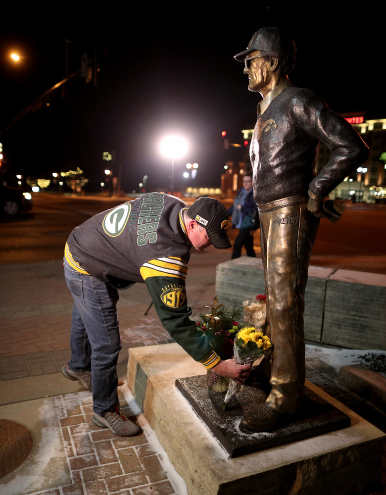 Mourners lay flowers at the statue of former Hawkeye Football Head Coach Hayden Fry Tuesday, December 17, 2019 in Coralville. Fry passed away on Tuesday at the age of 90. (Brian Ray/hawkeyesports.com)