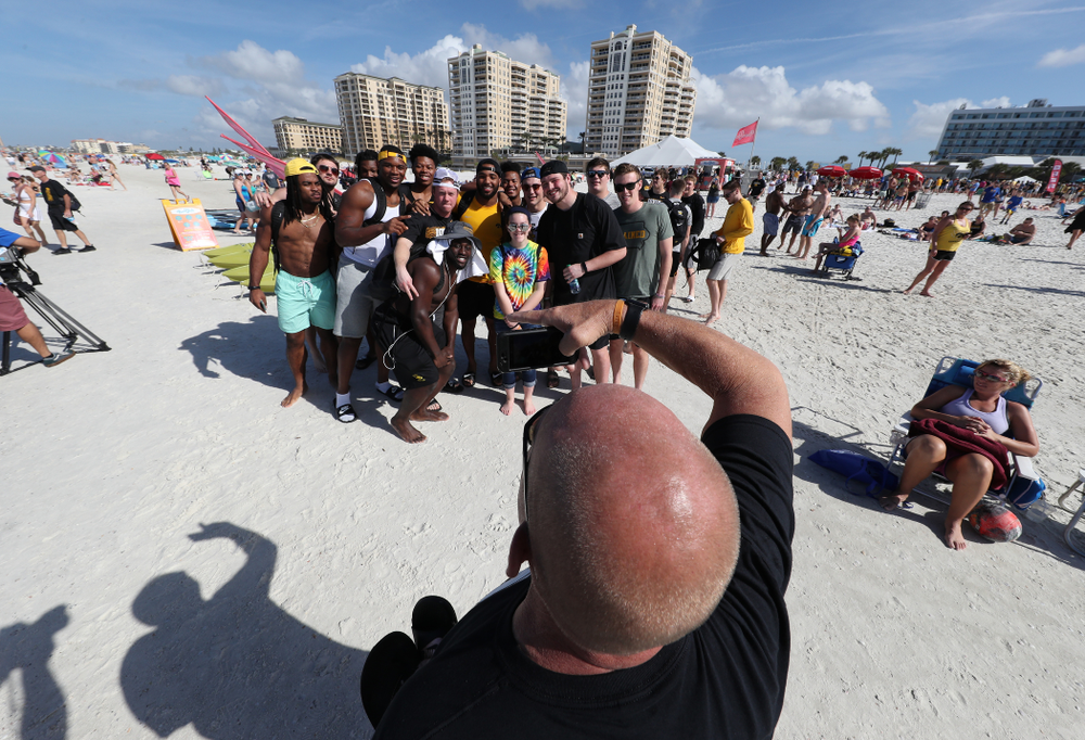 The Iowa Hawkeyes take photo with fans during the Outback Bowl Beach Day Sunday, December 30, 2018 at Clearwater Beach. (Brian Ray/hawkeyesports.com)
