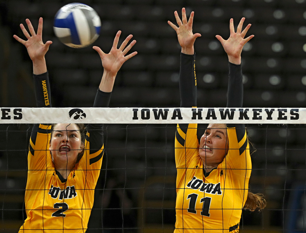 Iowa’s Blythe Rients (11) gets a block as Courtney Buzzerio (2) looks on during their match at Carver-Hawkeye Arena in Iowa City on Sunday, Oct 20, 2019. (Stephen Mally/hawkeyesports.com)