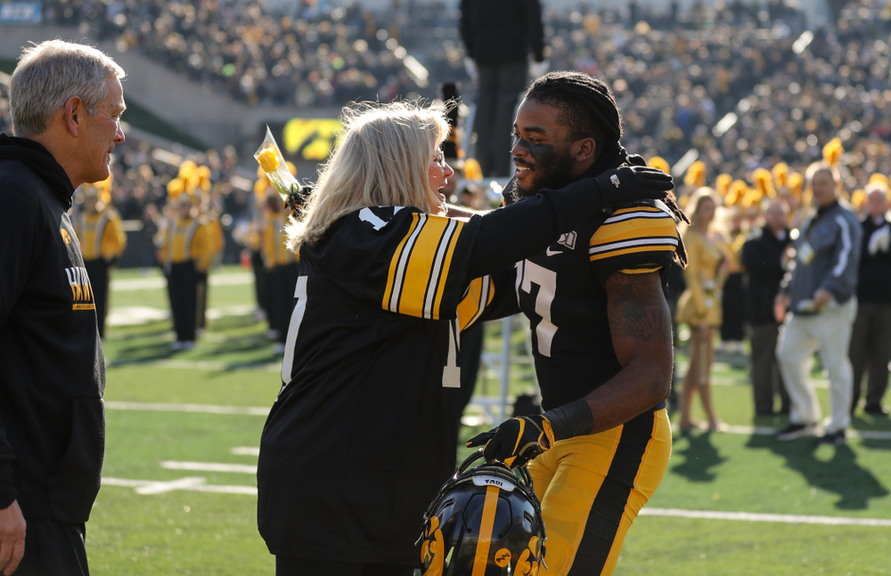 Iowa Hawkeyes defensive back Devonte Young (17) and Kirk and Mary Ferentz during Senior Day festivities before their game against the Illinois Fighting Illini Saturday, November 23, 2019 at Kinnick Stadium. (Brian Ray/hawkeyesports.com)