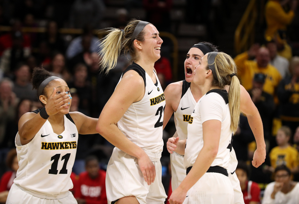 Iowa Hawkeyes forward Hannah Stewart (21) celebrates with forward Megan Gustafson (10), guard Tania Davis (11), and guard Makenzie Meyer (3) after getting a block and a steal late in the game against the Rutgers Scarlet Knights Wednesday, January 23, 2019 at Carver-Hawkeye Arena. (Brian Ray/hawkeyesports.com)