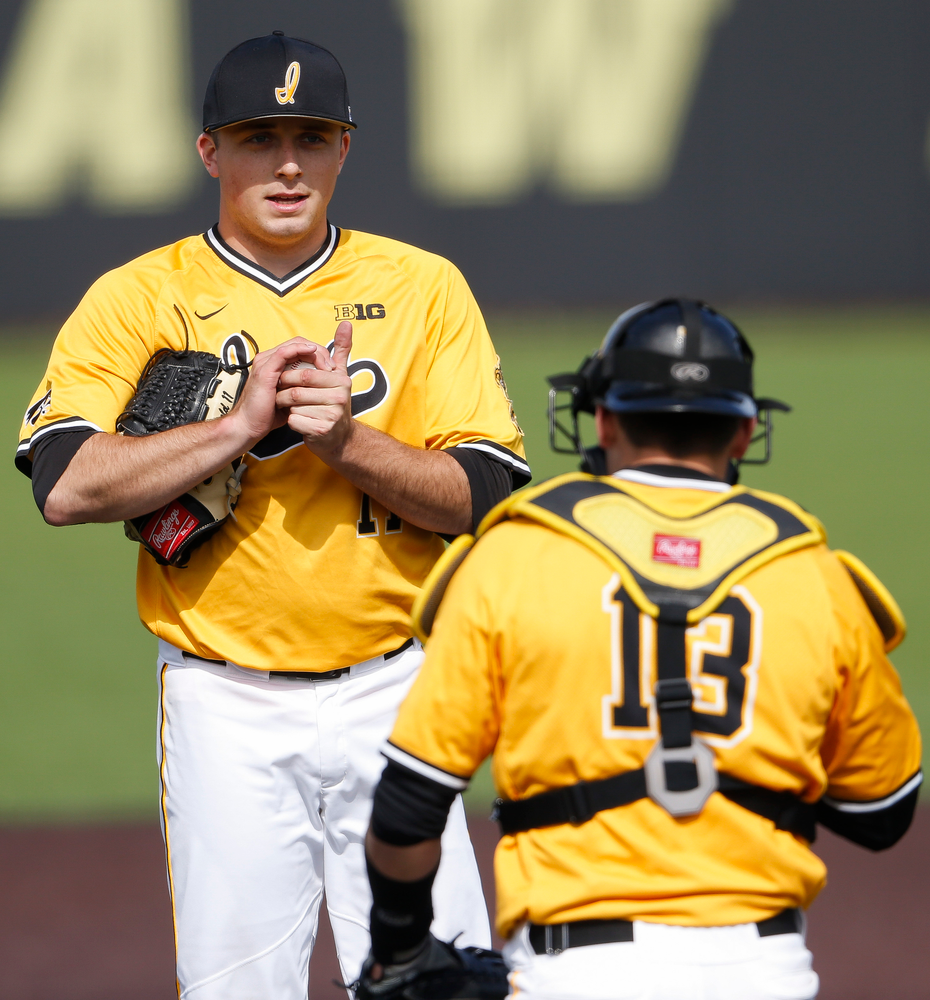 Iowa Hawkeyes pitcher Cole McDonald (11) talks with Iowa Hawkeyes catcher Matt Berst (13) during a game against Evansville at Duane Banks Field on March 18, 2018. (Tork Mason/hawkeyesports.com)