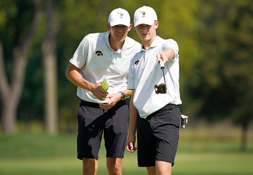 Iowa assistant coach Charlie Hoyle (from left) talks with Benton Weinberg during the second day of the Golfweek Conference Challenge at the Cedar Rapids Country Club in Cedar Rapids on Monday, Sep 16, 2019. (Stephen Mally/hawkeyesports.com)