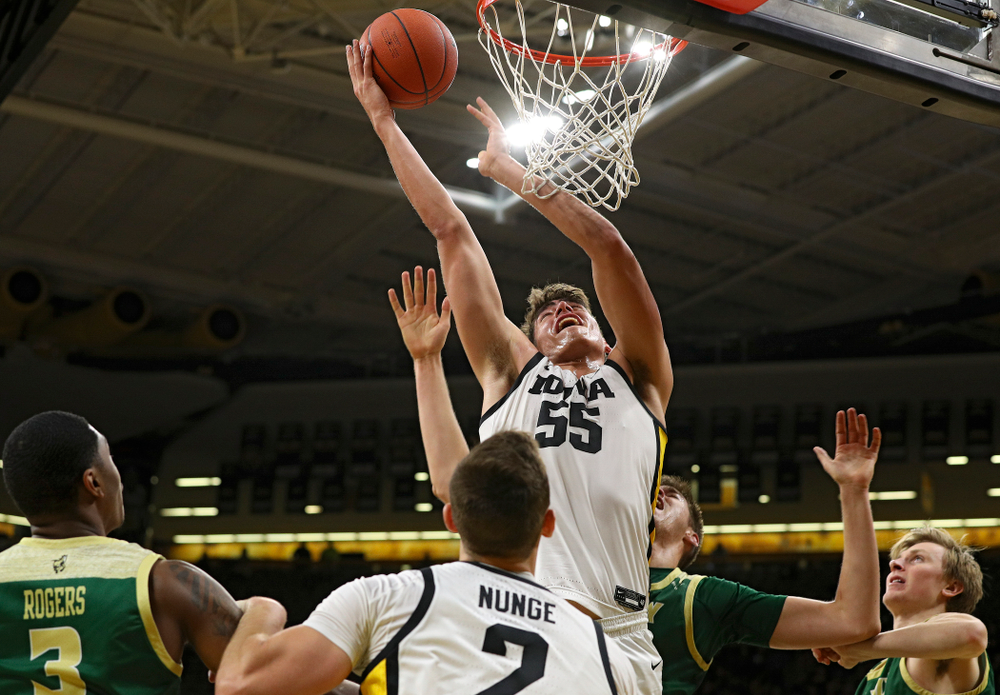 Iowa Hawkeyes center Luka Garza (55) scores a basket as forward Jack Nunge (2) looks on during the first half of their game at Carver-Hawkeye Arena in Iowa City on Sunday, Nov 24, 2019. (Stephen Mally/hawkeyesports.com)
