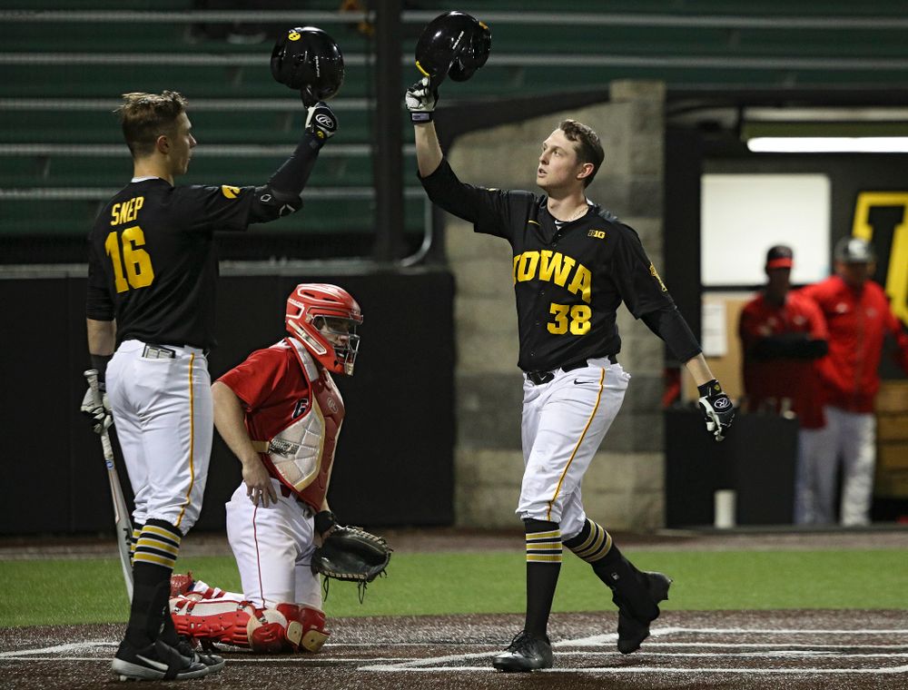 Iowa designated hitter Trenton Wallace (38) is greeted by catcher Tyler Snep (16) after hitting a home run during the eighth inning of their game at Duane Banks Field in Iowa City on Tuesday, March 3, 2020. (Stephen Mally/hawkeyesports.com)