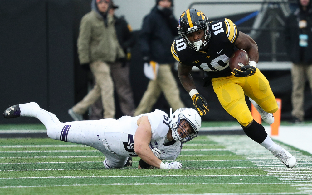 Iowa Hawkeyes running back Mekhi Sargent (10) breaks a tackle during a game against Northwestern at Kinnick Stadium on November 10, 2018. (Tork Mason/hawkeyesports.com)
