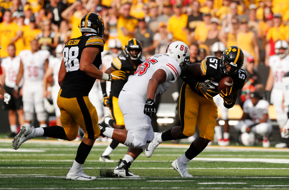 Iowa Hawkeyes defensive end Chauncey Golston (57) scoops up and returns a fumble against the Northern Illinois Huskies Saturday, September 1, 2018 at Kinnick Stadium. (Brian Ray/hawkeyesports.com)