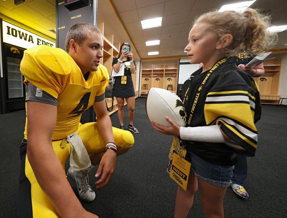 Iowa Hawkeyes quarterback Nate Stanley (4) talks with Kid Captain Charlotte Keller during Kids Day at Kinnick Stadium in Iowa City on Saturday, Aug 10, 2019. (Stephen Mally/hawkeyesports.com)