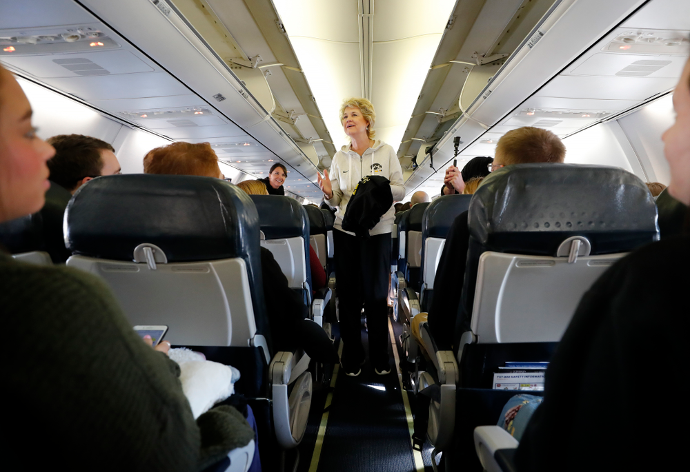 Iowa Hawkeyes head coach Lisa Bluder hands out t-shirts to the pep band and spirit squad to thank them as they travel to Los Angeles for the first round of the 2018 NCAA Tournament Thursday, March 15, 2018 at the Eastern Iowa Airport. (Brian Ray/hawkeyesports.com)