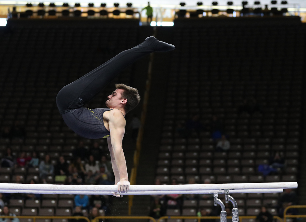 Iowa's Mitch Mandozzi competes on the parallel bars against the Ohio State Buckeyes Saturday, March 16, 2019 at Carver-Hawkeye Arena. (Brian Ray/hawkeyesports.com)