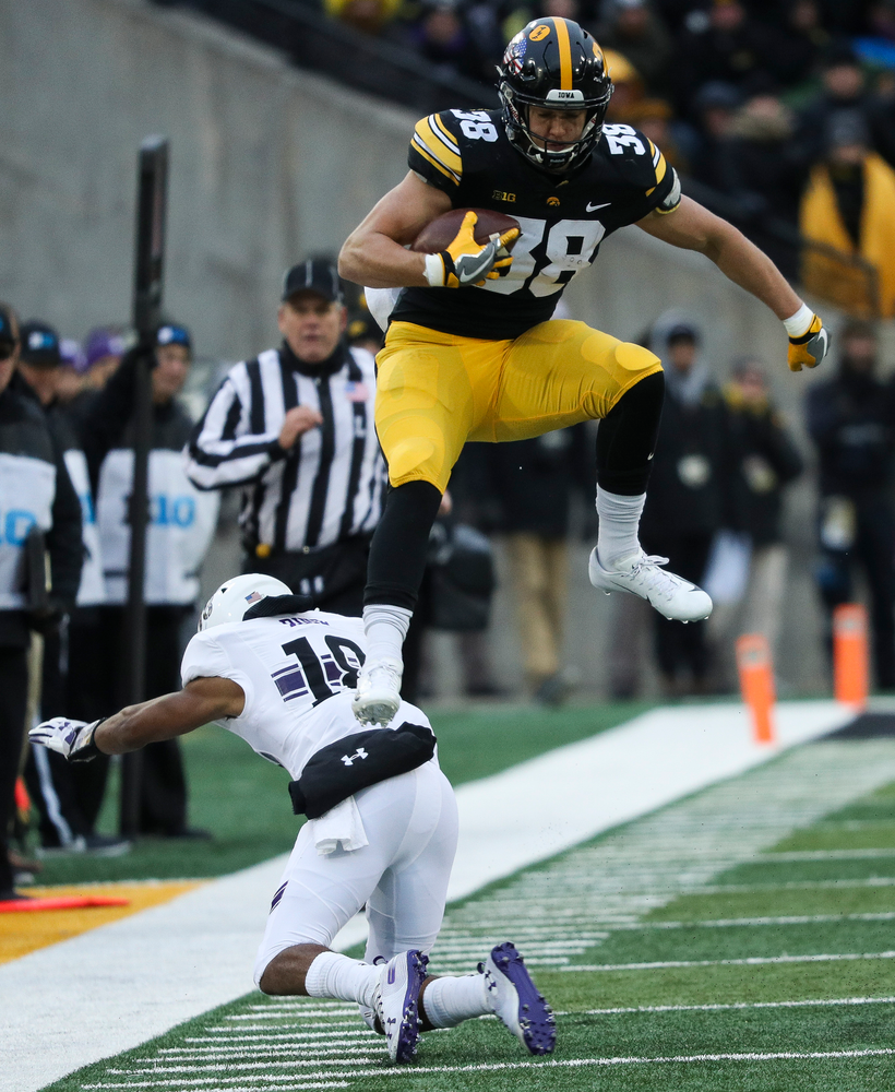 Iowa Hawkeyes tight end T.J. Hockenson (38) hurdles a defender during a game against Northwestern at Kinnick Stadium on November 10, 2018. (Tork Mason/hawkeyesports.com)