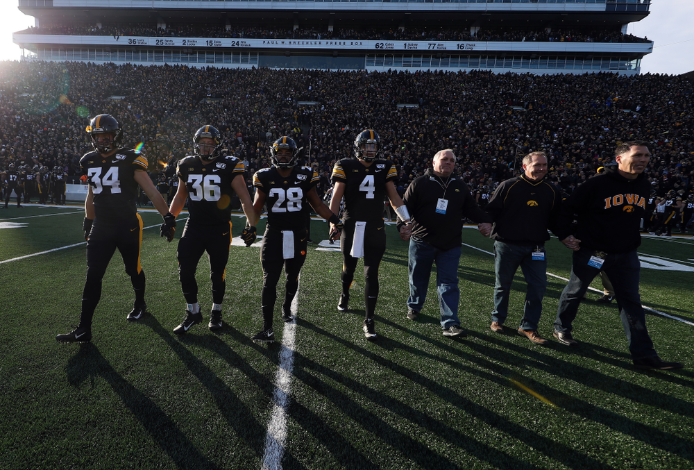 Iowa Hawkeyes captains linebacker Kristian Welch (34), fullback Brady Ross (36), running back Toren Young (28), and quarterback Nate Stanley (4) against the Minnesota Golden Gophers Saturday, November 16, 2019 at Kinnick Stadium. (Brian Ray/hawkeyesports.com)
