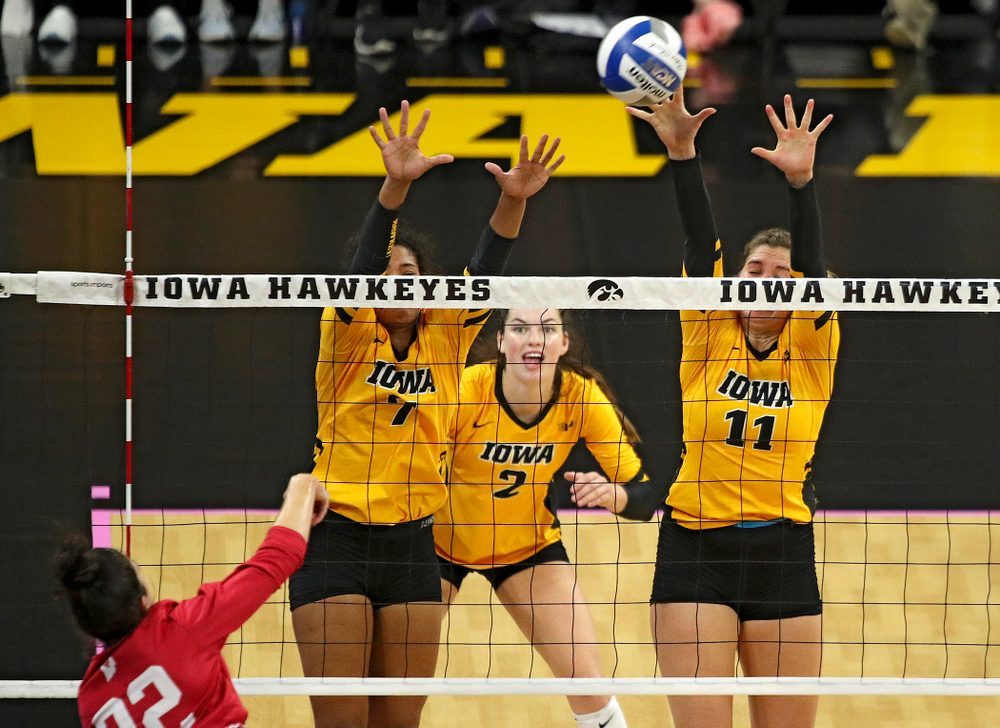Iowa’s Blythe Rients (11) gets a block as Brie Orr (7) and Courtney Buzzerio (2) look on during their match at Carver-Hawkeye Arena in Iowa City on Sunday, Oct 20, 2019. (Stephen Mally/hawkeyesports.com)