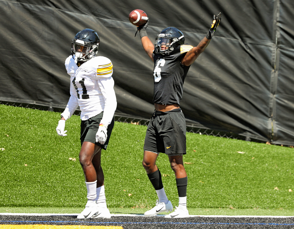 Iowa Hawkeyes wide receiver Ihmir Smith-Marsette (6) celebrates after pulling in a touchdown around defensive back Michael Ojemudia (11) during Fall Camp Practice No. 7 at the Hansen Football Performance Center in Iowa City on Friday, Aug 9, 2019. (Stephen Mally/hawkeyesports.com)