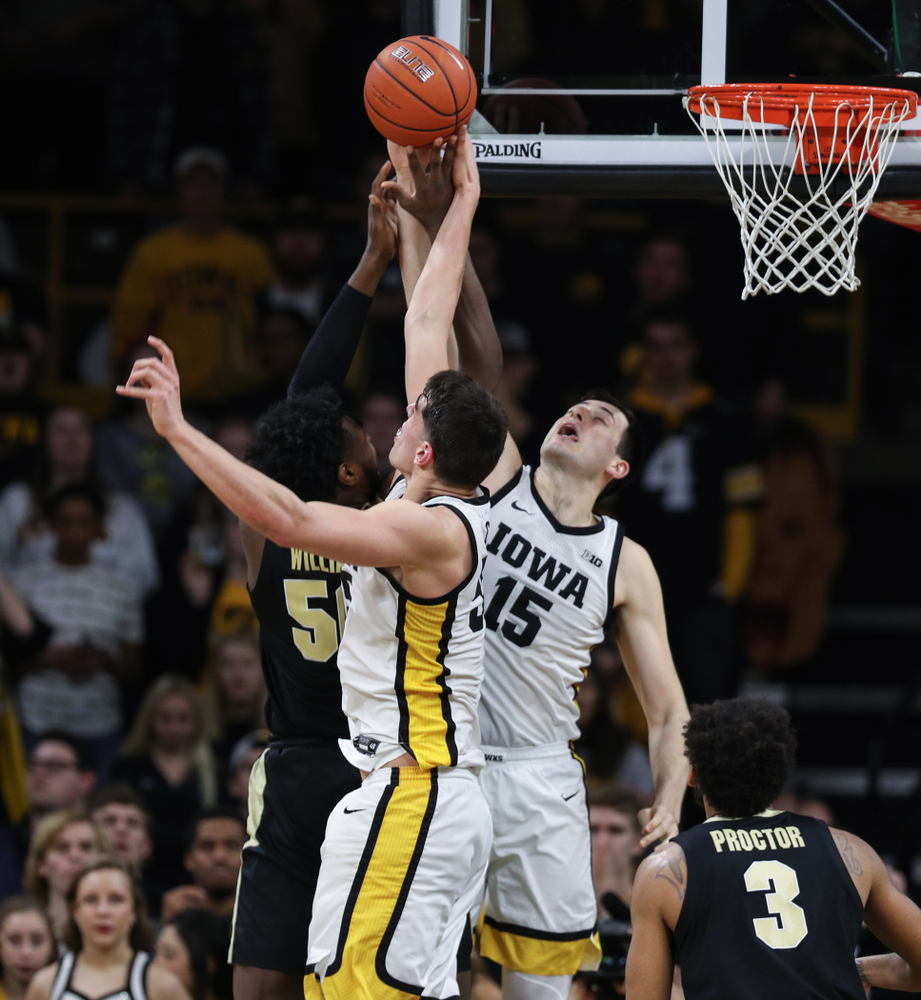 Iowa Hawkeyes forward Ryan Kriener (15) blocks a shot against the Purdue Boilermakers Tuesday, March 3, 2020 at Carver-Hawkeye Arena. (Brian Ray/hawkeyesports.com)