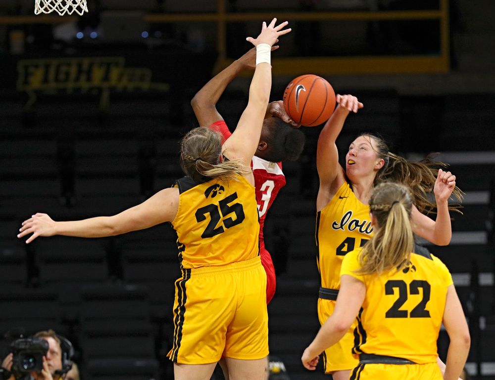 Iowa Hawkeyes forward Amanda Ollinger (43) blocks a shot by Ohio State Buckeyes guard Janai Crooms (3) as forward Monika Czinano (25) defends during the third quarter of their game at Carver-Hawkeye Arena in Iowa City on Thursday, January 23, 2020. (Stephen Mally/hawkeyesports.com)