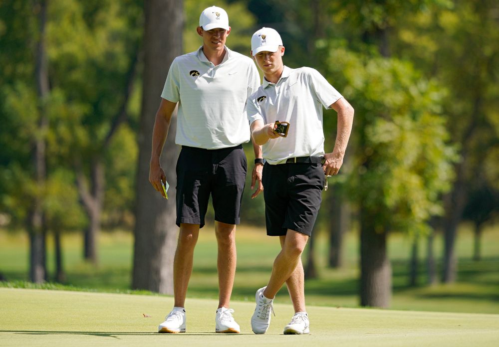 Iowa assistant coach Charlie Hoyle (from left) talks with Benton Weinberg during the second day of the Golfweek Conference Challenge at the Cedar Rapids Country Club in Cedar Rapids on Monday, Sep 16, 2019. (Stephen Mally/hawkeyesports.com)