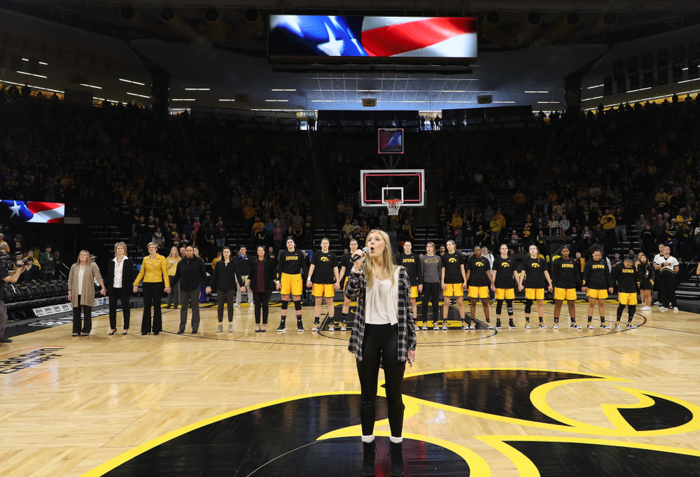 Iowa Hawkeyes head coach Lisa Bluder watches as her daughter Emma sings the National Anthem before the Iowa Hawkeyes game against the Northwestern Wildcats Sunday, March 3, 2019 at Carver-Hawkeye Arena. (Brian Ray/hawkeyesports.com)