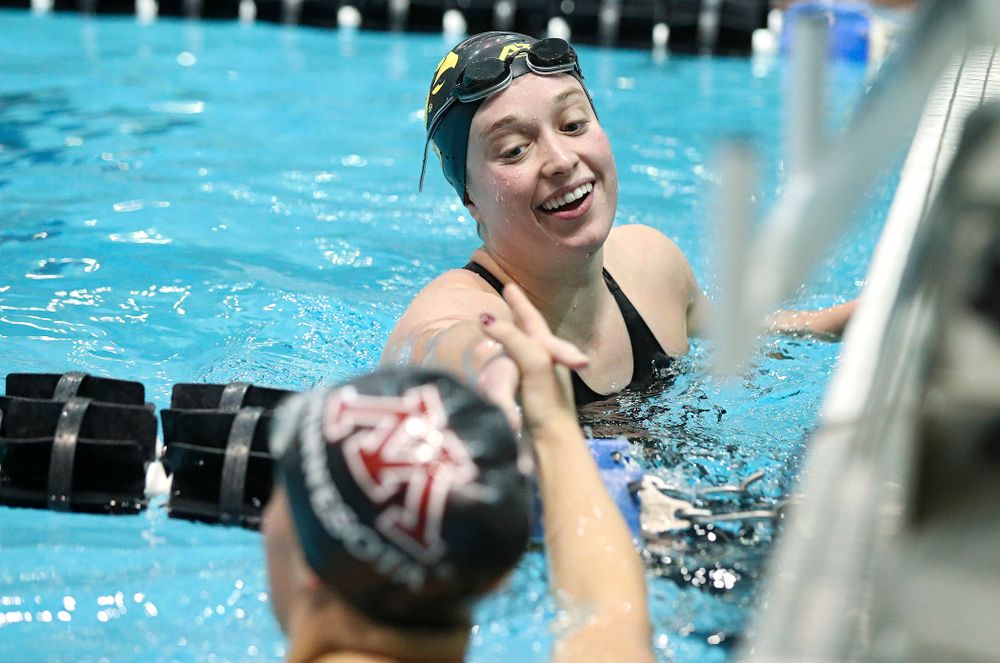 Iowa’s Kelsey Drake shakes hands with Minnesota’s Tevyn Waddell after swimming the women’s 100 yard butterfly final event during the 2020 Women’s Big Ten Swimming and Diving Championships at the Campus Recreation and Wellness Center in Iowa City on Friday, February 21, 2020. (Stephen Mally/hawkeyesports.com)