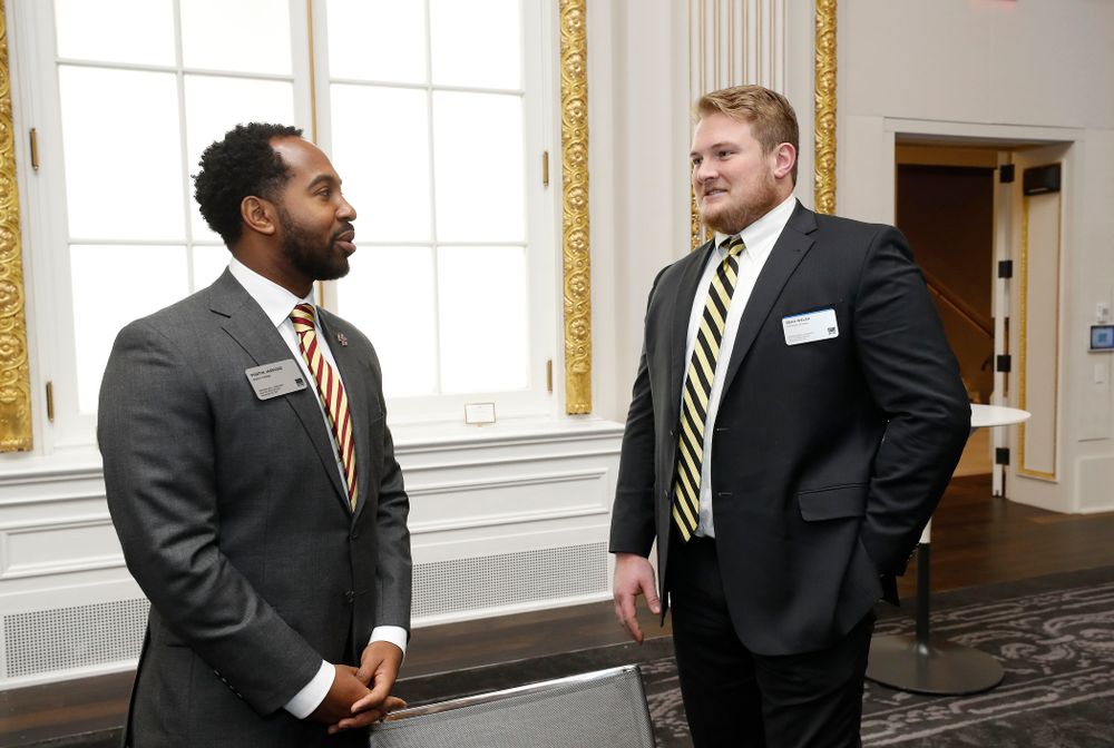 Iowa Hawkeyes linebacker Josey Jewell (43), defensive back Joshua Jackson (15), offensive lineman Sean Welsh (79) and head coach Kirk Ferentz ring the opening bell at the New York Stock Exchange Tuesday, December 26, 2017 in New York. (Brian Ray/hawkeyesports.com)