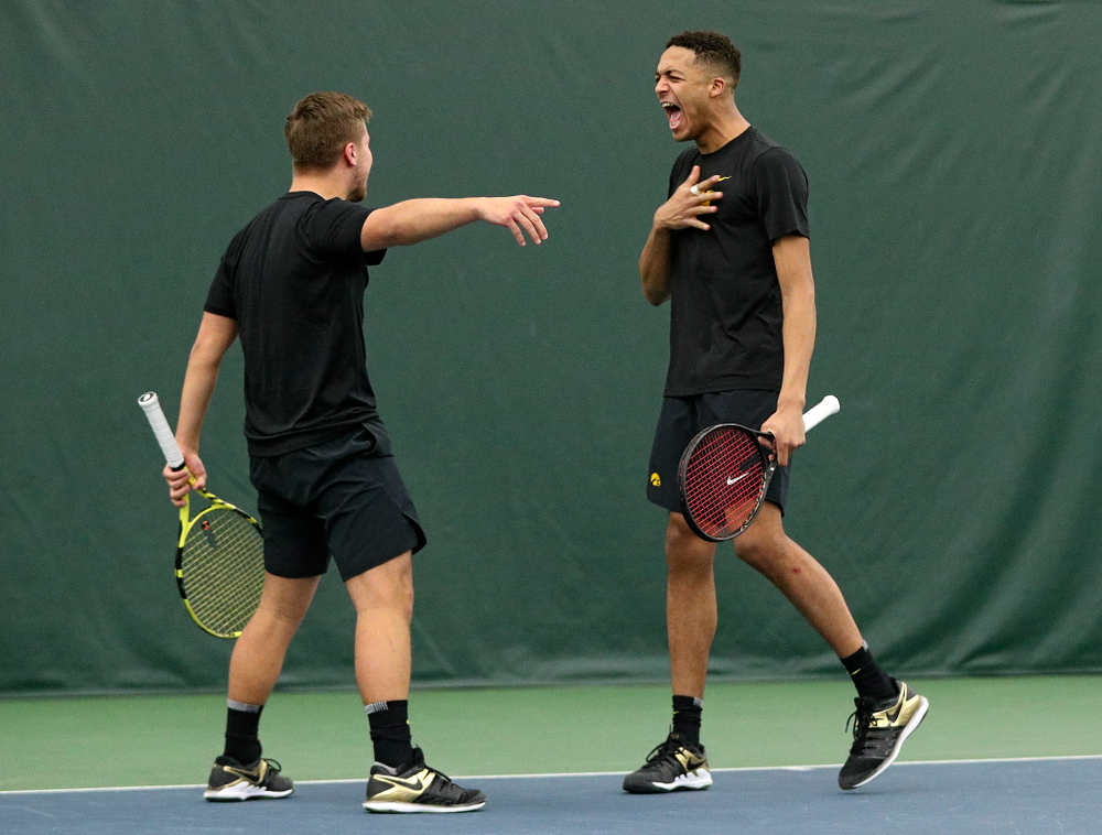 Iowa’s Will Davies (from left) and Oliver Okonkwo celebrate a point during their doubles match at the Hawkeye Tennis and Recreation Complex in Iowa City on Friday, February 14, 2020. (Stephen Mally/hawkeyesports.com)