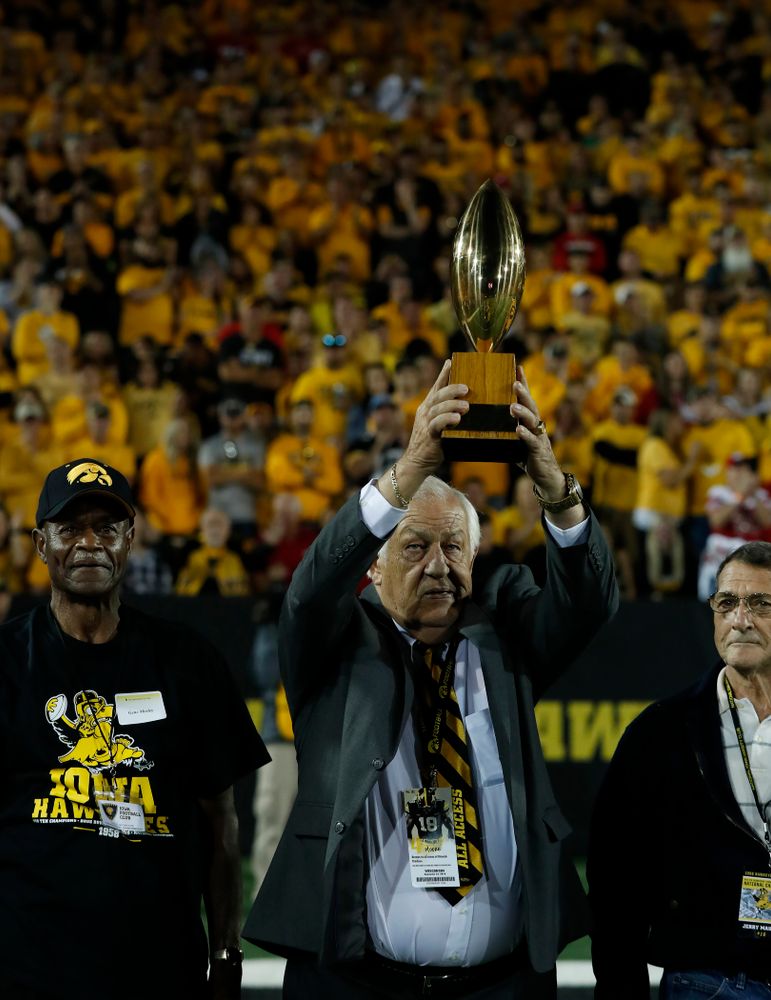 Tom Moore holds up the 19058 National Championship trophy as the team is introduced during the Iowa Hawkeyes game against the Wisconsin Badgers Saturday, September 22, 2018 at Kinnick Stadium. (Brian Ray/hawkeyesports.com)