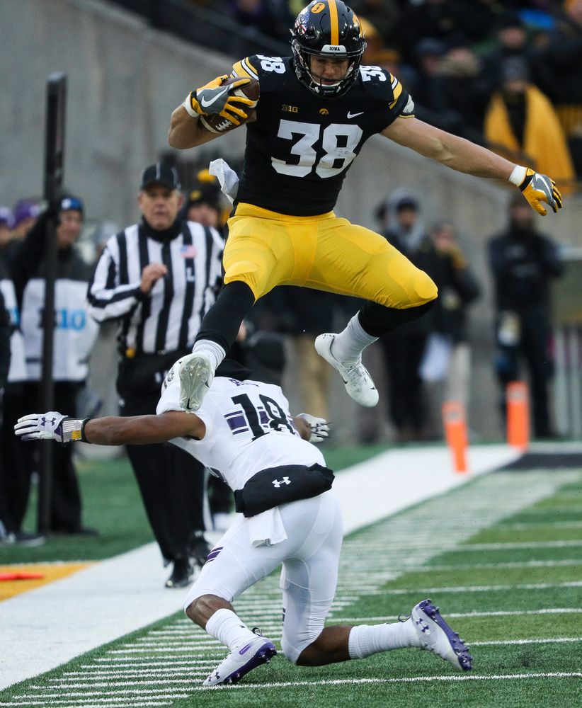 Iowa Hawkeyes tight end T.J. Hockenson (38) hurdles a defender during a game against Northwestern at Kinnick Stadium on November 10, 2018. (Tork Mason/hawkeyesports.com)