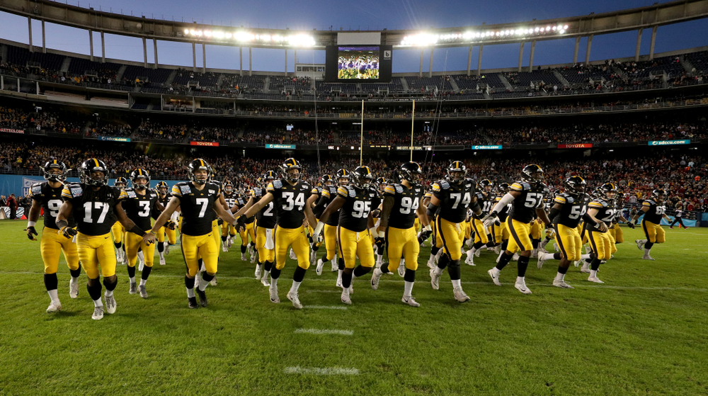 The Iowa Hawkeyes swarm onto the field against USC in the Holiday Bowl Friday, December 27, 2019 at San Diego Community Credit Union Stadium. (Brian Ray/hawkeyesports.com)