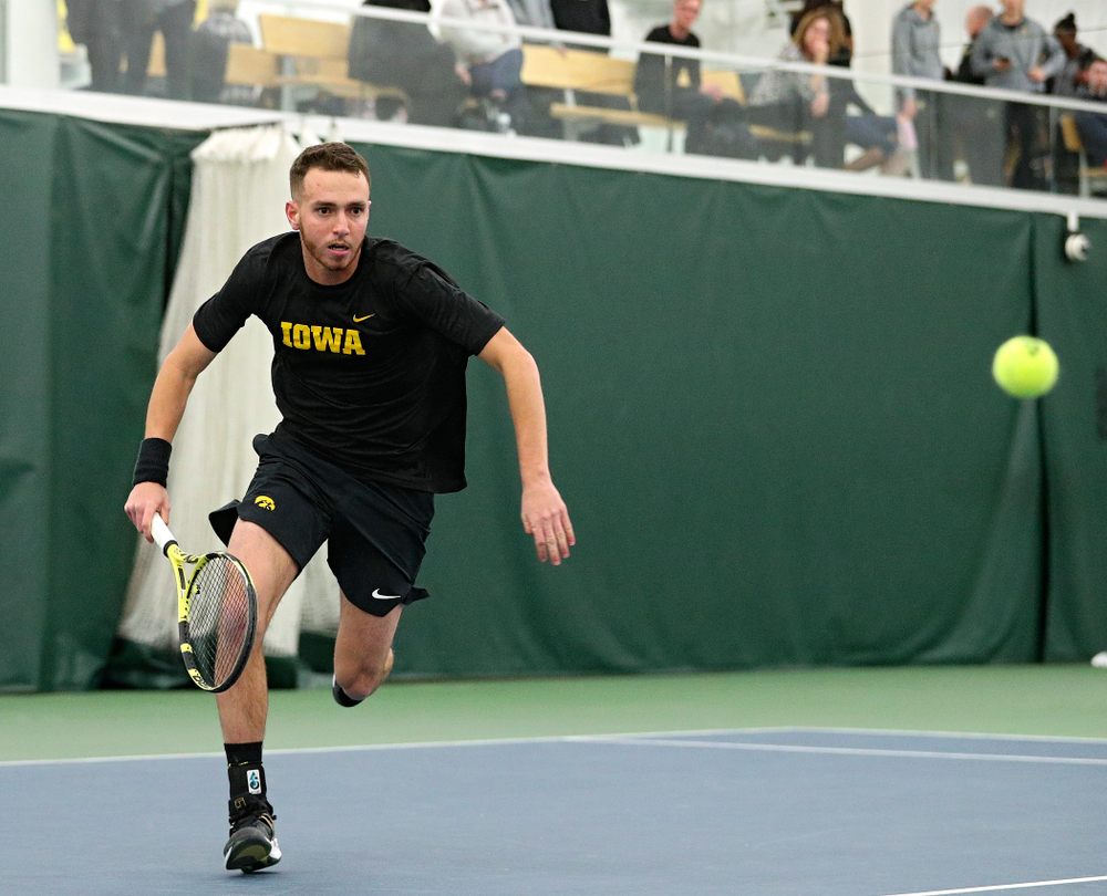 Iowa’s Kareem Allaf runs down a ball during his singles match at the Hawkeye Tennis and Recreation Complex in Iowa City on Friday, February 14, 2020. (Stephen Mally/hawkeyesports.com)